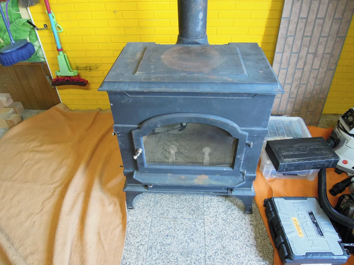 屋根の上で煙突を点検する作業風景