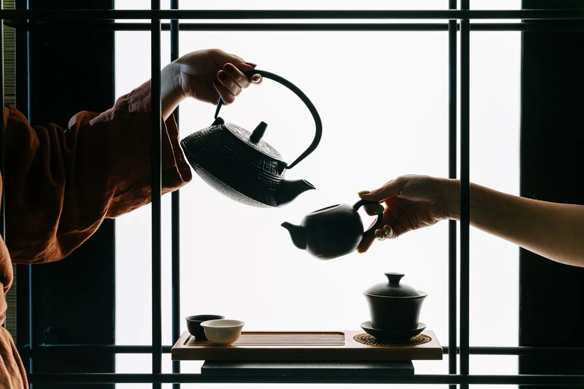 伝統的な茶道で丁寧に茶を注ぐ二人